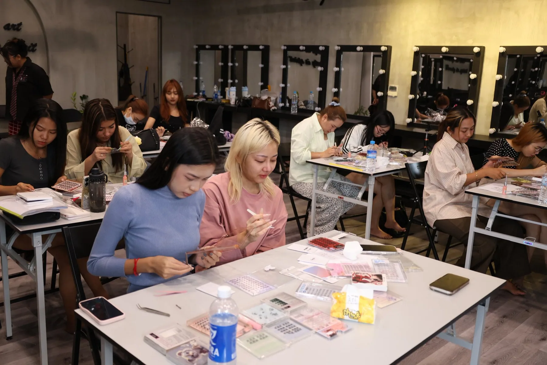 Makeup students participating in a practical training session